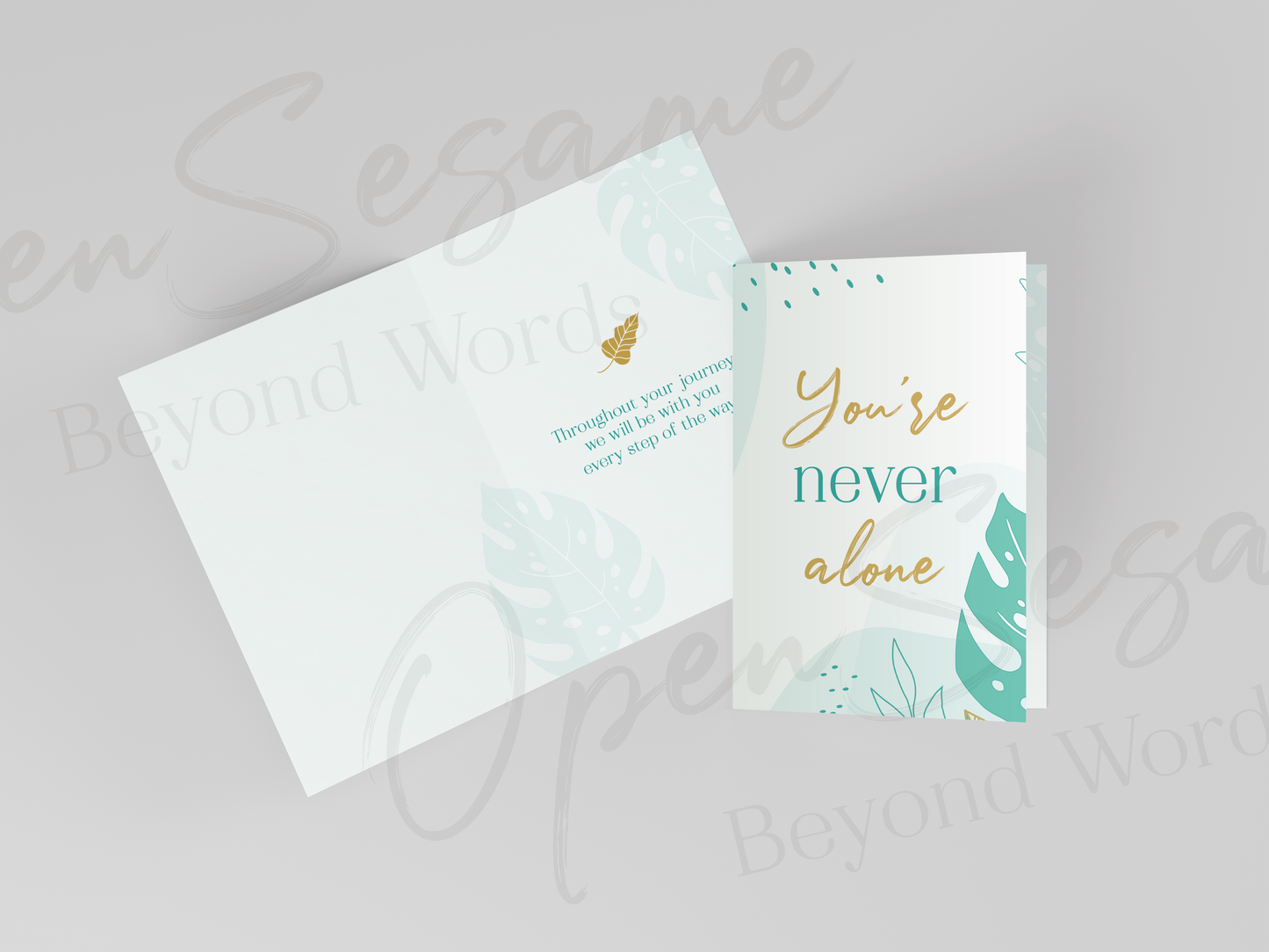 Front of card in support of those with cancer that reads ‘You're Never Alone’. Also shows message displayed on inside of card.