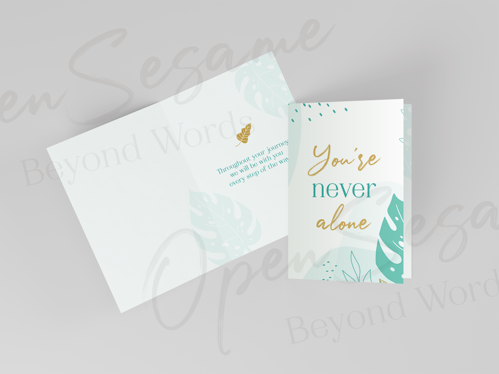Front of card in support of those with cancer that reads ‘You're Never Alone’. Also shows message displayed on inside of card.